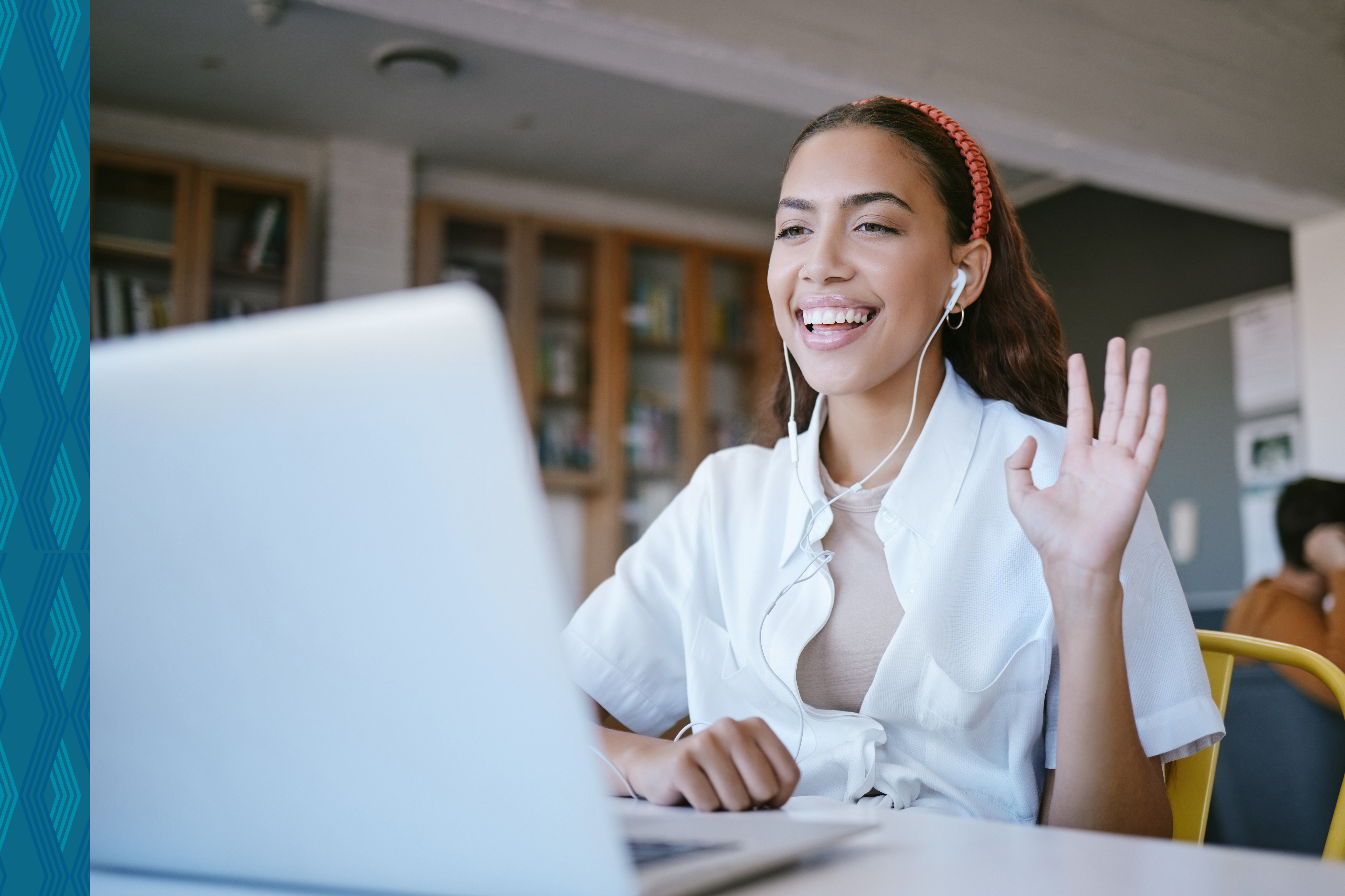 A young teacher joins an online class on a laptop computer
