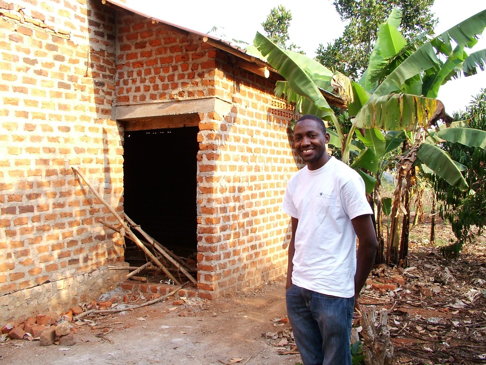 Fellow Charles Batte and the village library he is constructing in Katiiti Village, Mpigi District